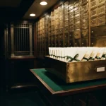 Brass safe-deposit drawer holding a row of sealed envelopes, reflecting the 24Casino review