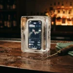 Smartphone sealed in a block of ice on a bar counter, a nod to the Betpanda review