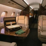 Attache case of banded envelopes in a private jet cabin, reflecting the Bitcasino.io review