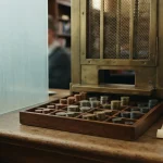 Tray of many kinds of coins at an exchange window, reflecting the Coldbet review