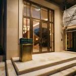 New venue entrance with scaffolding and sealed folders on a podium, illustrating the Drakaris review