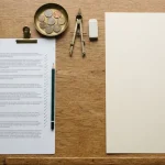 Terms page under a steel ruler and green pencil on a drafting table, illustrating the King Billy review