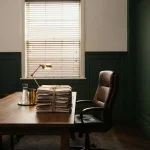 Empty chair facing a stack of case files, illustrating the Kingmaker review