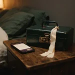 Locked cash box with a ribbon tag next to a phone, showing the Luckiest Casino review