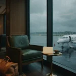 Private jet waiting in the rain beyond a lounge window, illustrating the NV Casino review