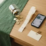 Jar of gold tokens, prize tickets and a face-down ID card, showing the StakeUS review